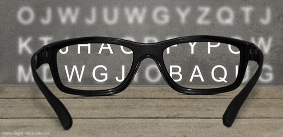 Brille mit Buchstaben im Hintergrund